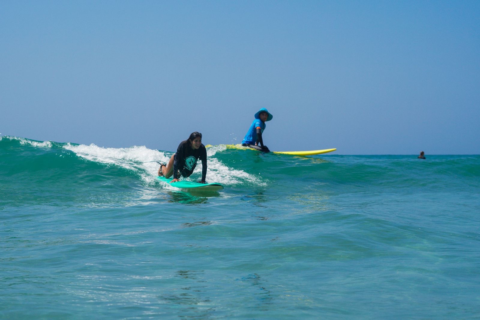 Beginner surfers catching a gentle wave near Taghazout