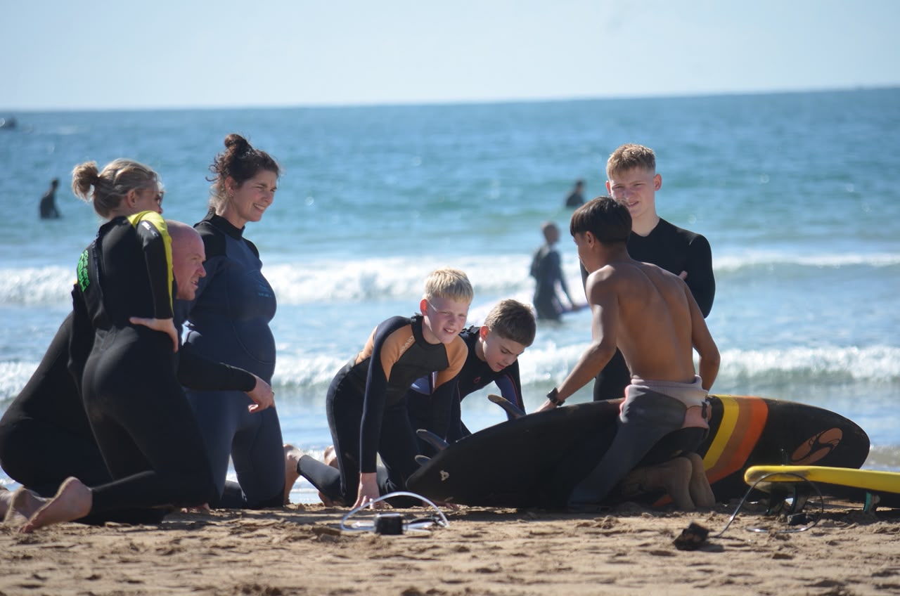 Mohamed coaching a surf group on the beach