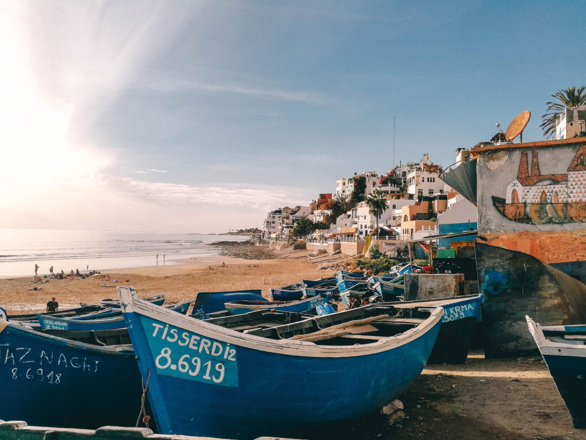 Blue fishing boats on the beach in Taghazout village
